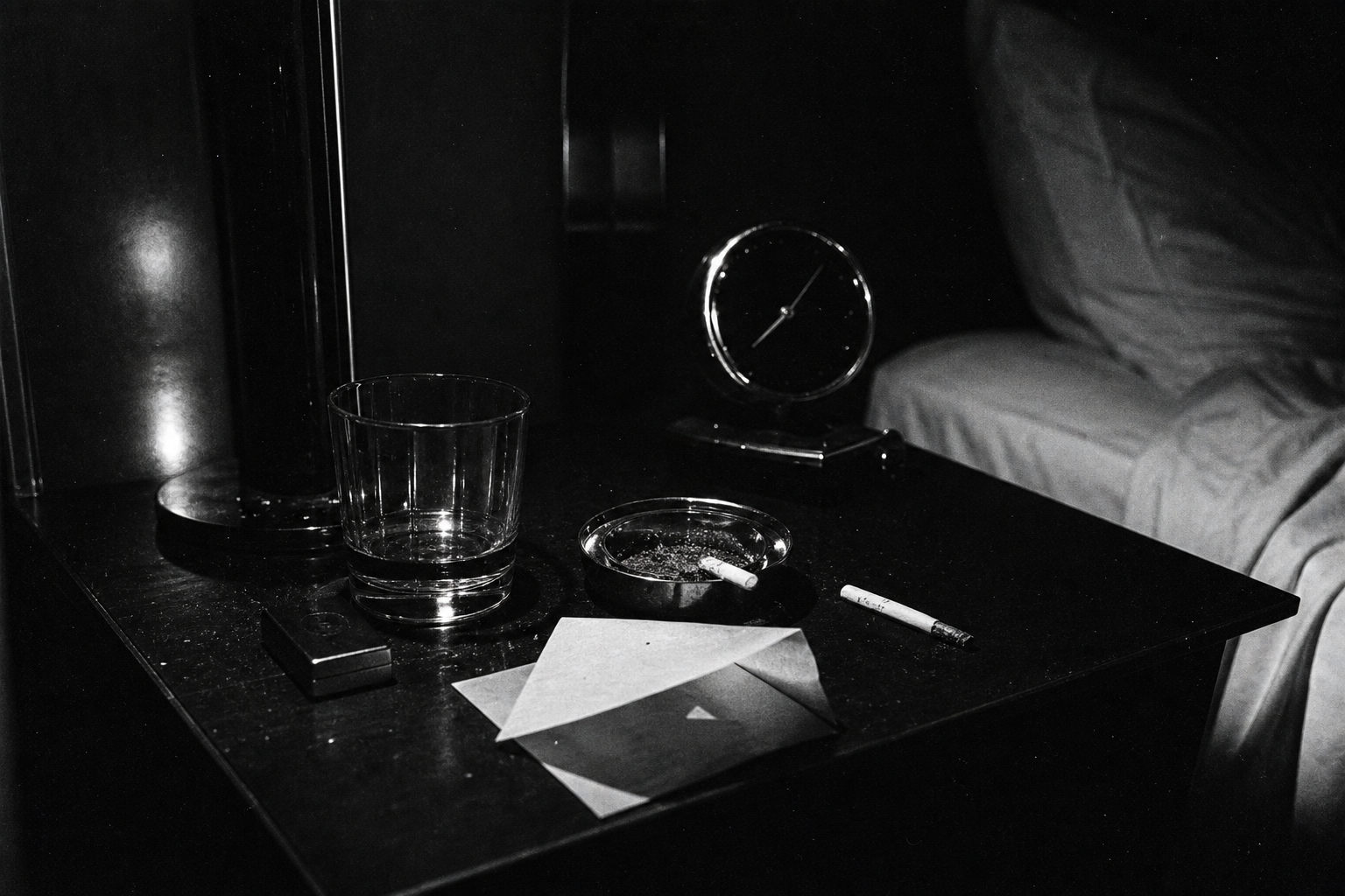 Chrome objects on a dark bedside table